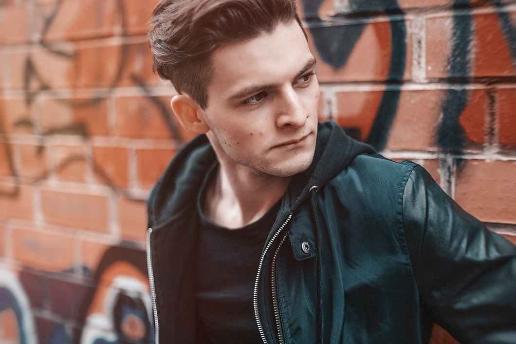 close up photography of man wearing leather jacket