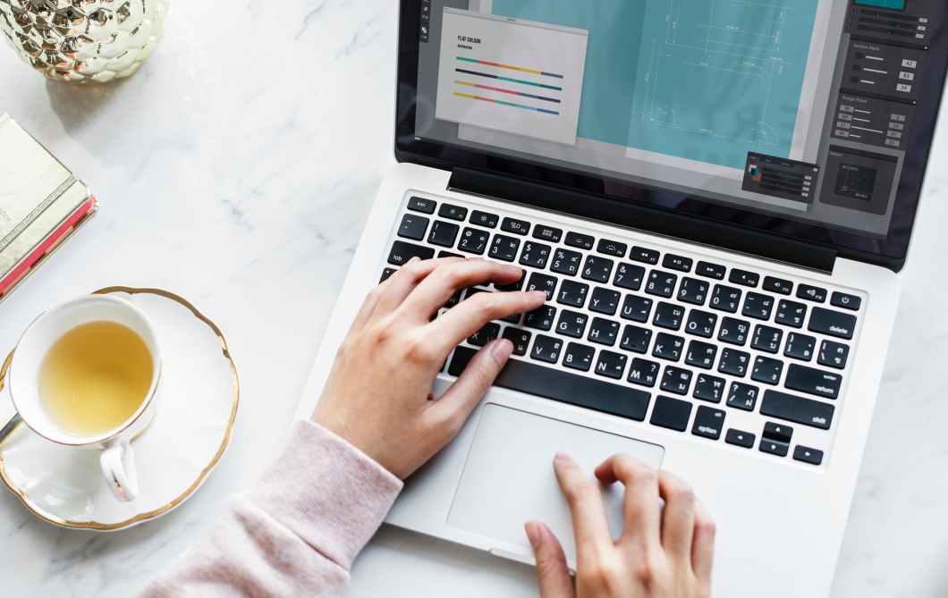 woman holding macbook pro